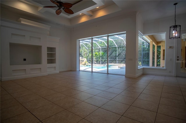 unfurnished living room featuring built in shelves, tile flooring, and ceiling fan