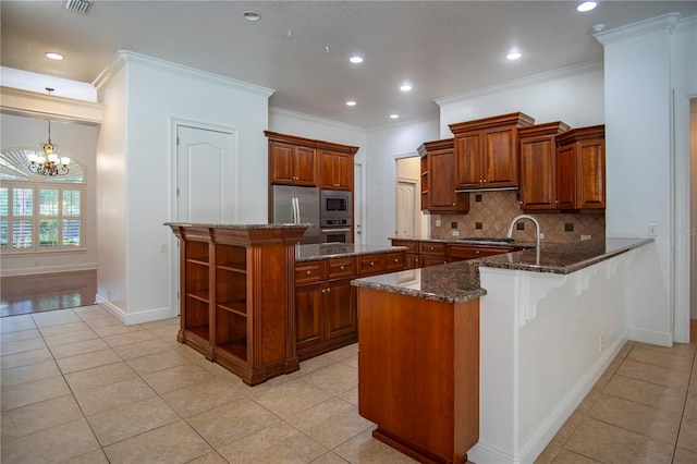 kitchen featuring appliances with stainless steel finishes, light tile floors, a kitchen island, backsplash, and dark stone countertops