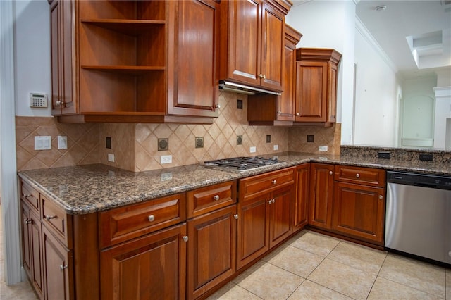 kitchen with crown molding, backsplash, stainless steel appliances, light tile floors, and dark stone counters