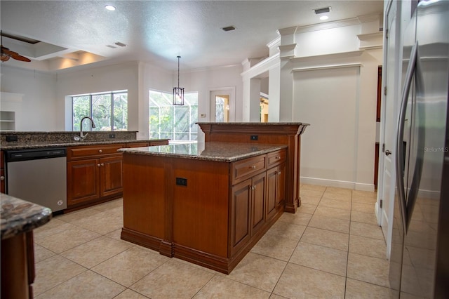 kitchen featuring stainless steel appliances, a kitchen island, dark stone countertops, ceiling fan, and a textured ceiling