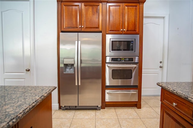 kitchen featuring light tile floors and stainless steel appliances