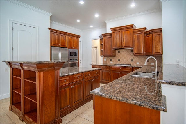 kitchen with light tile flooring, stainless steel appliances, sink, tasteful backsplash, and dark stone counters