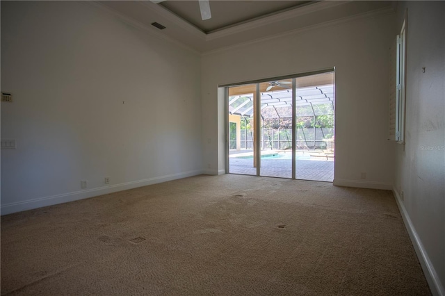 spare room with a high ceiling, crown molding, and carpet floors