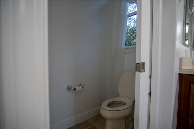 bathroom with vanity, tile floors, and toilet