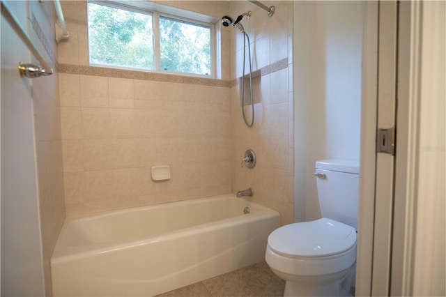 bathroom with toilet, tile floors, and tiled shower / bath combo