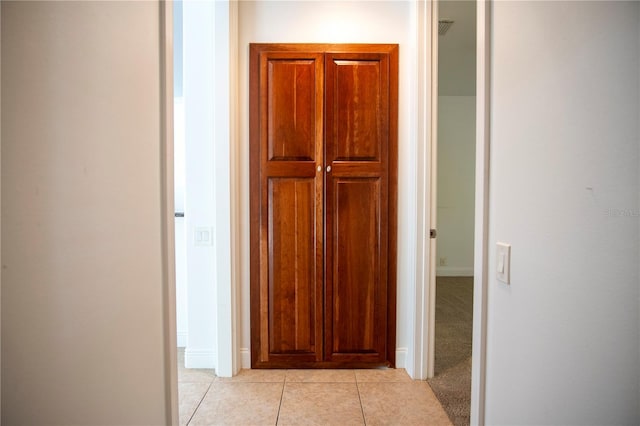 corridor featuring light tile flooring