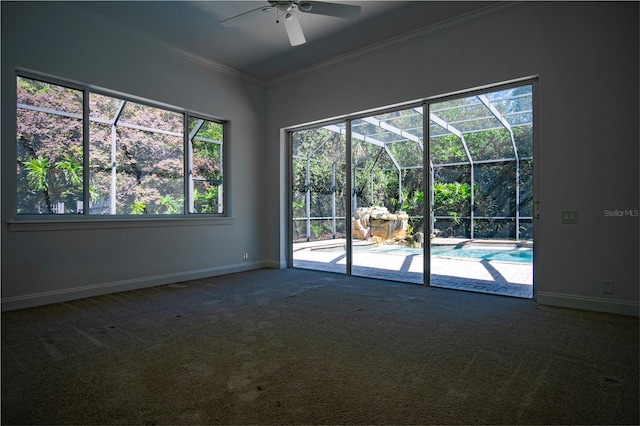 carpeted spare room featuring ceiling fan and ornamental molding