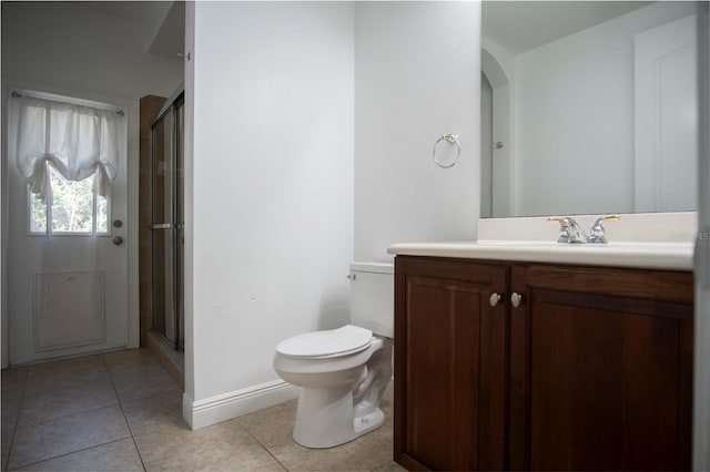 bathroom with walk in shower, vanity, toilet, and tile flooring