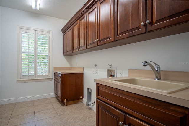 washroom featuring cabinets, sink, hookup for a washing machine, and light tile flooring