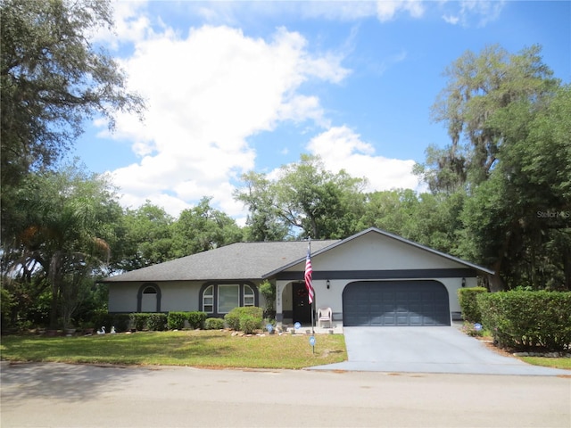 ranch-style house featuring a garage and a front yard