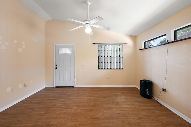 foyer entrance with lofted ceiling, hardwood / wood-style floors, and ceiling fan