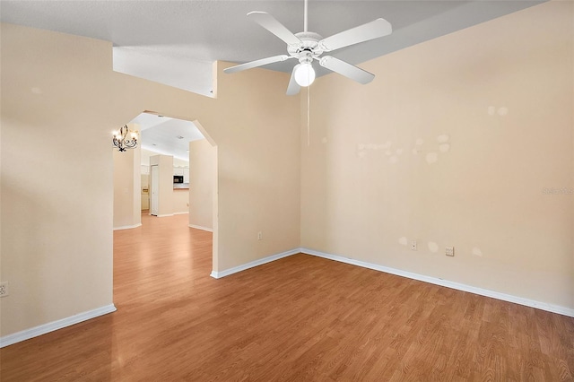 spare room featuring vaulted ceiling, hardwood / wood-style floors, and ceiling fan