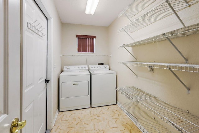 washroom featuring light tile floors, hookup for a washing machine, and washer and dryer