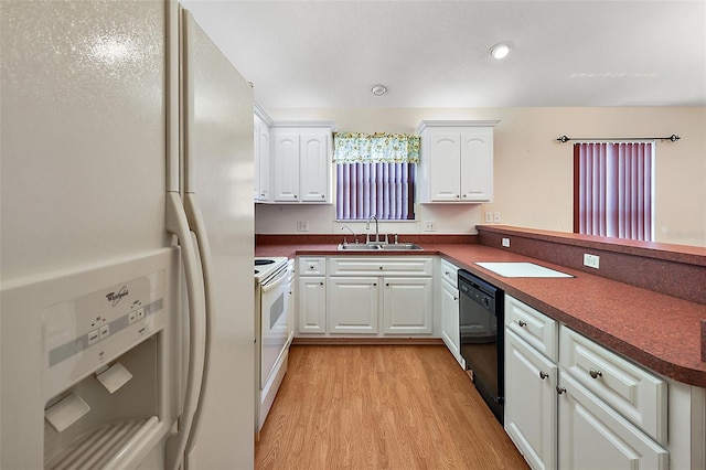 kitchen with kitchen peninsula, white appliances, light hardwood / wood-style floors, white cabinets, and sink