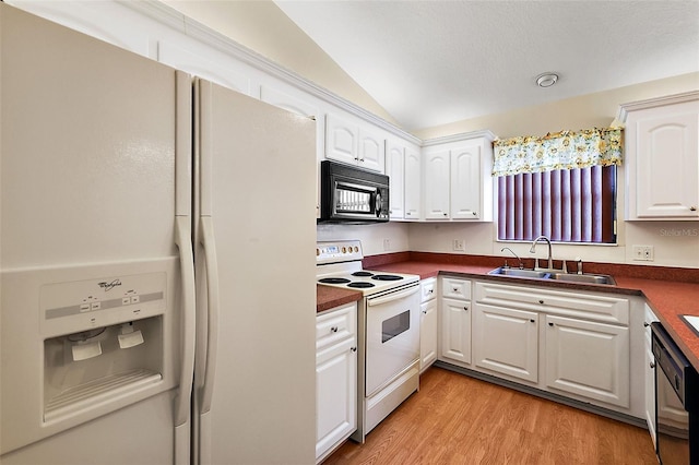 kitchen featuring sink, white appliances, light wood-type flooring, white cabinetry, and vaulted ceiling