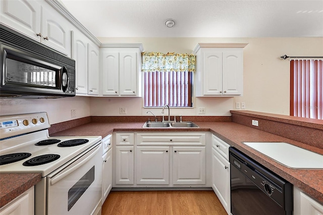 kitchen with white cabinetry, light hardwood / wood-style floors, black appliances, and sink