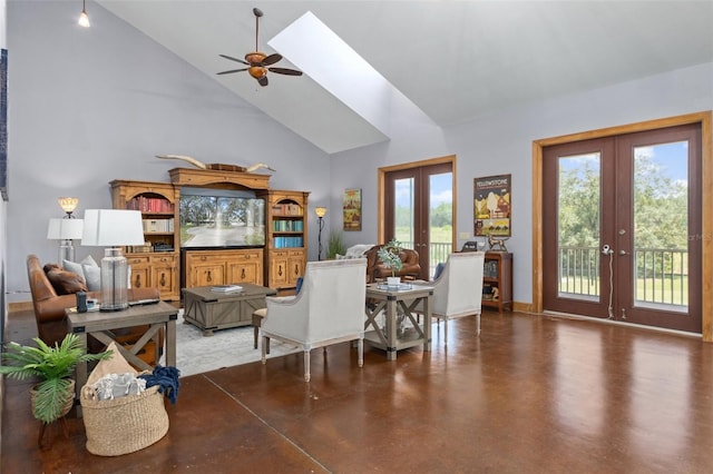 living room with french doors, a skylight, ceiling fan, and high vaulted ceiling