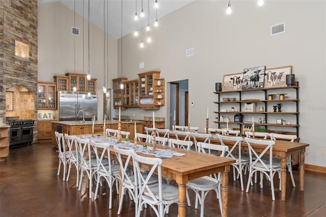 dining space with high vaulted ceiling