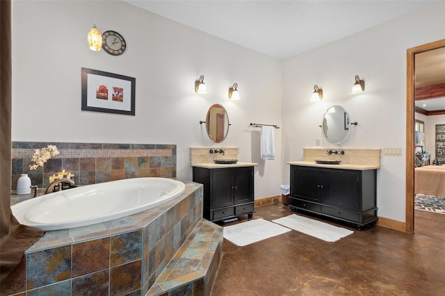 bathroom featuring tiled tub and dual vanity