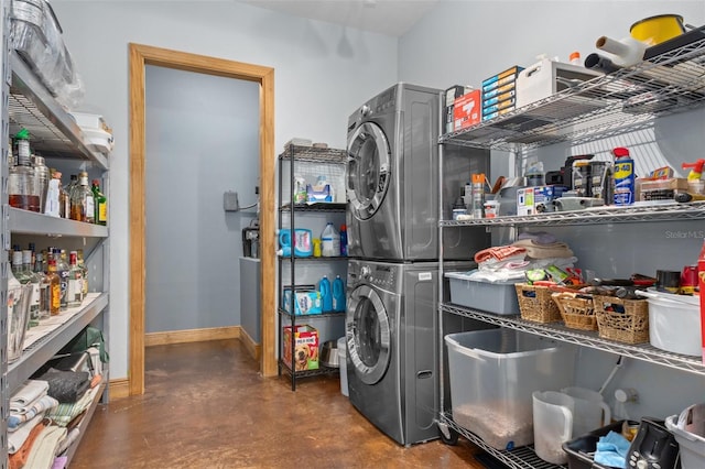 pantry featuring stacked washing maching and dryer