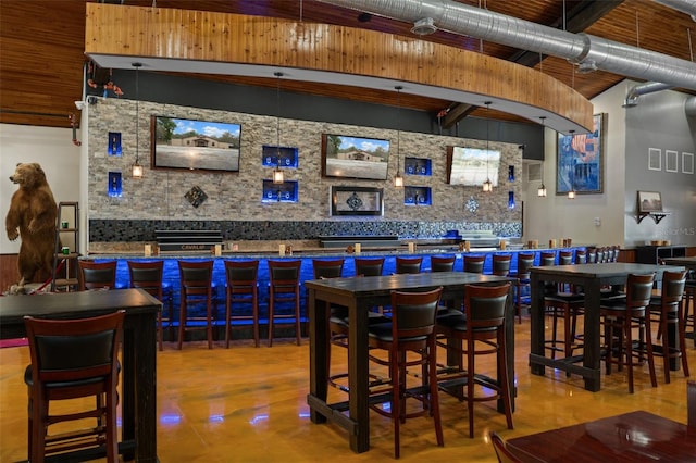 bar featuring a towering ceiling