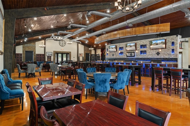 interior space featuring wooden ceiling, high vaulted ceiling, a chandelier, and beamed ceiling