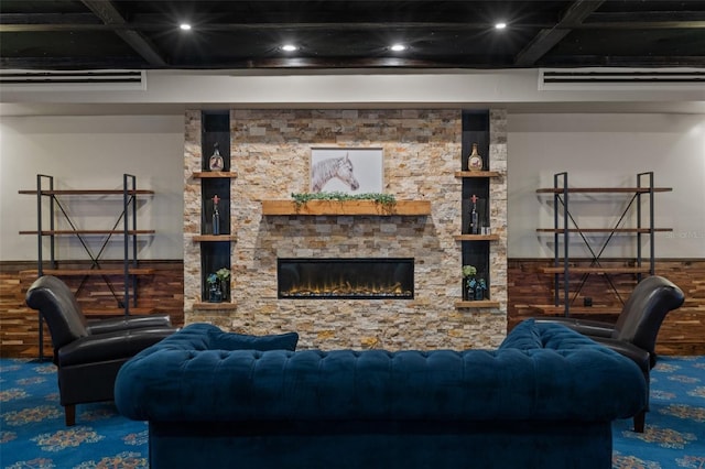 living room featuring beam ceiling, a stone fireplace, and coffered ceiling