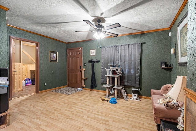 living area featuring hardwood / wood-style floors, ceiling fan, and a textured ceiling