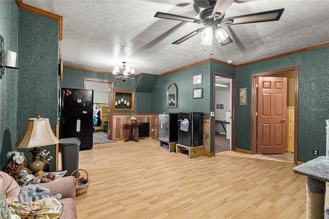 living room with ceiling fan with notable chandelier, hardwood / wood-style flooring, crown molding, and a textured ceiling