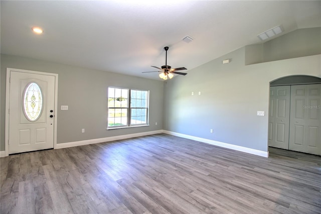 foyer entrance with vaulted ceiling, light hardwood / wood-style flooring, and ceiling fan