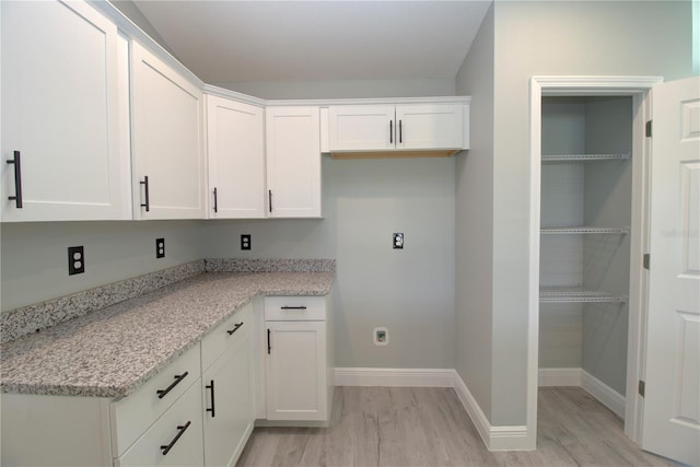 laundry area featuring light hardwood / wood-style floors