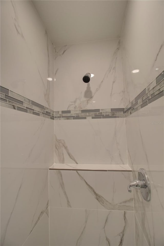 bathroom with a tile shower