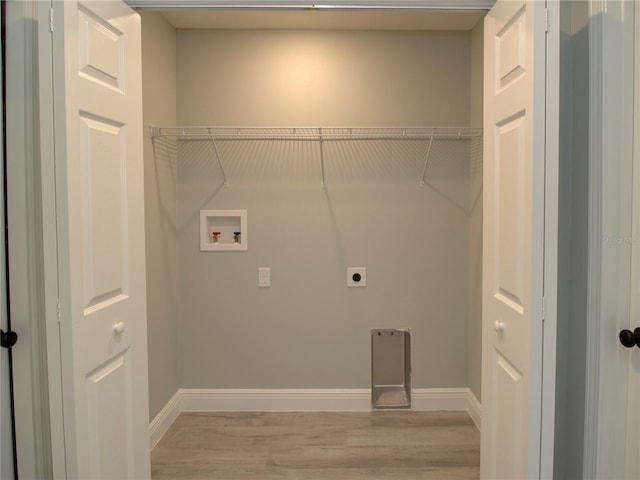 laundry area featuring electric dryer hookup, washer hookup, and light wood-type flooring