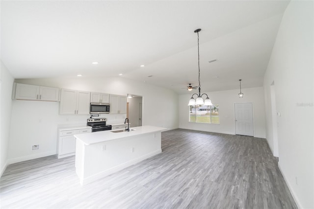 kitchen with a center island with sink, light countertops, appliances with stainless steel finishes, light wood-style floors, and a sink