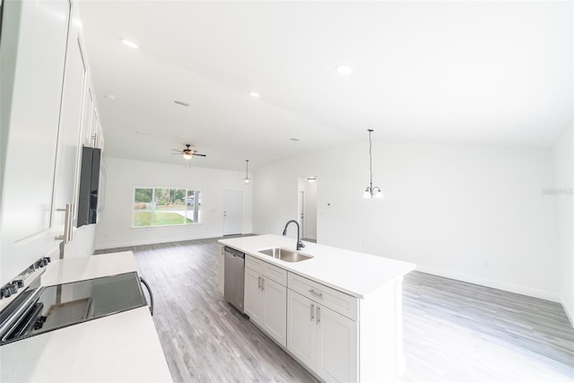 kitchen with a sink, white cabinetry, open floor plan, and dishwasher