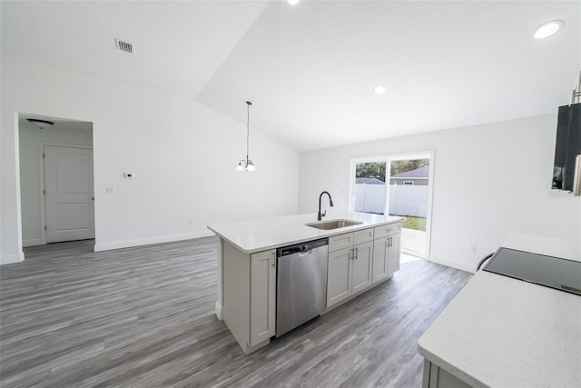 kitchen with light countertops, visible vents, stainless steel dishwasher, vaulted ceiling, and a sink