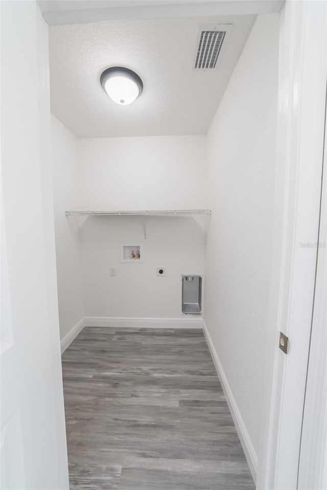 washroom featuring laundry area, washer hookup, wood finished floors, visible vents, and electric dryer hookup