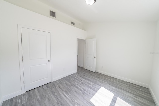 unfurnished bedroom with baseboards and visible vents