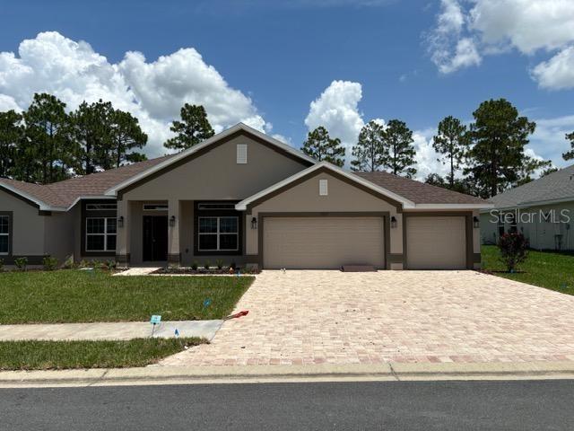 view of front of house with a garage and a front lawn