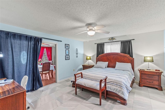 bedroom featuring a textured ceiling and ceiling fan