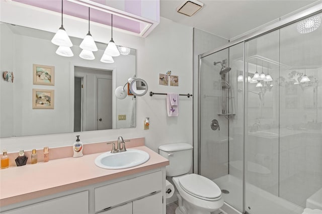 bathroom with vanity, toilet, and an enclosed shower