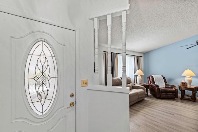 entrance foyer with ceiling fan, light hardwood / wood-style floors, and a textured ceiling