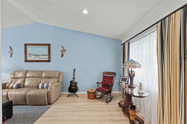 living room with light hardwood / wood-style floors and vaulted ceiling