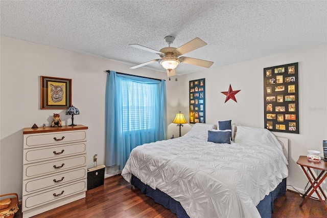 bedroom featuring dark hardwood / wood-style floors, ceiling fan, and a textured ceiling