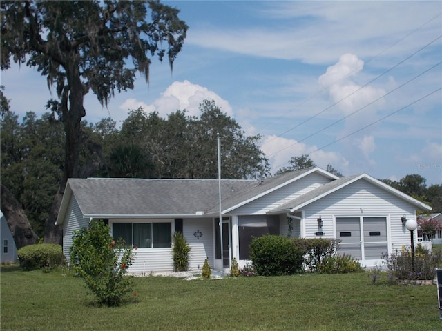 single story home with a garage and a front lawn