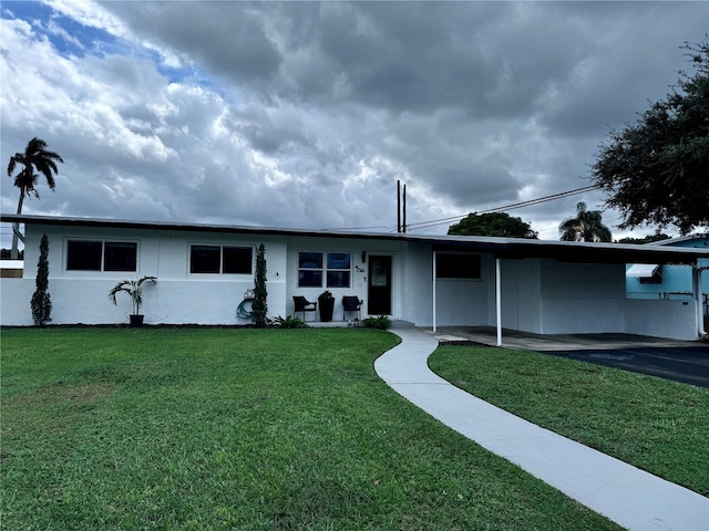 ranch-style house with a front lawn and a carport