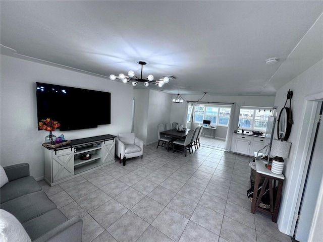 living room with a notable chandelier and light tile patterned flooring