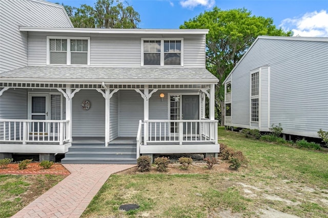 view of front facade with a front lawn and covered porch