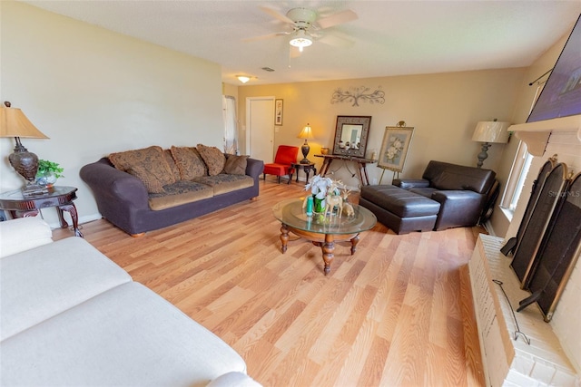 living room with light hardwood / wood-style flooring and ceiling fan