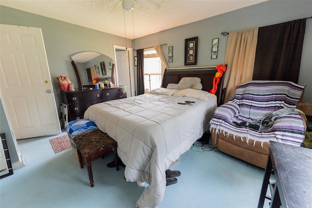 bedroom with ceiling fan and a textured ceiling